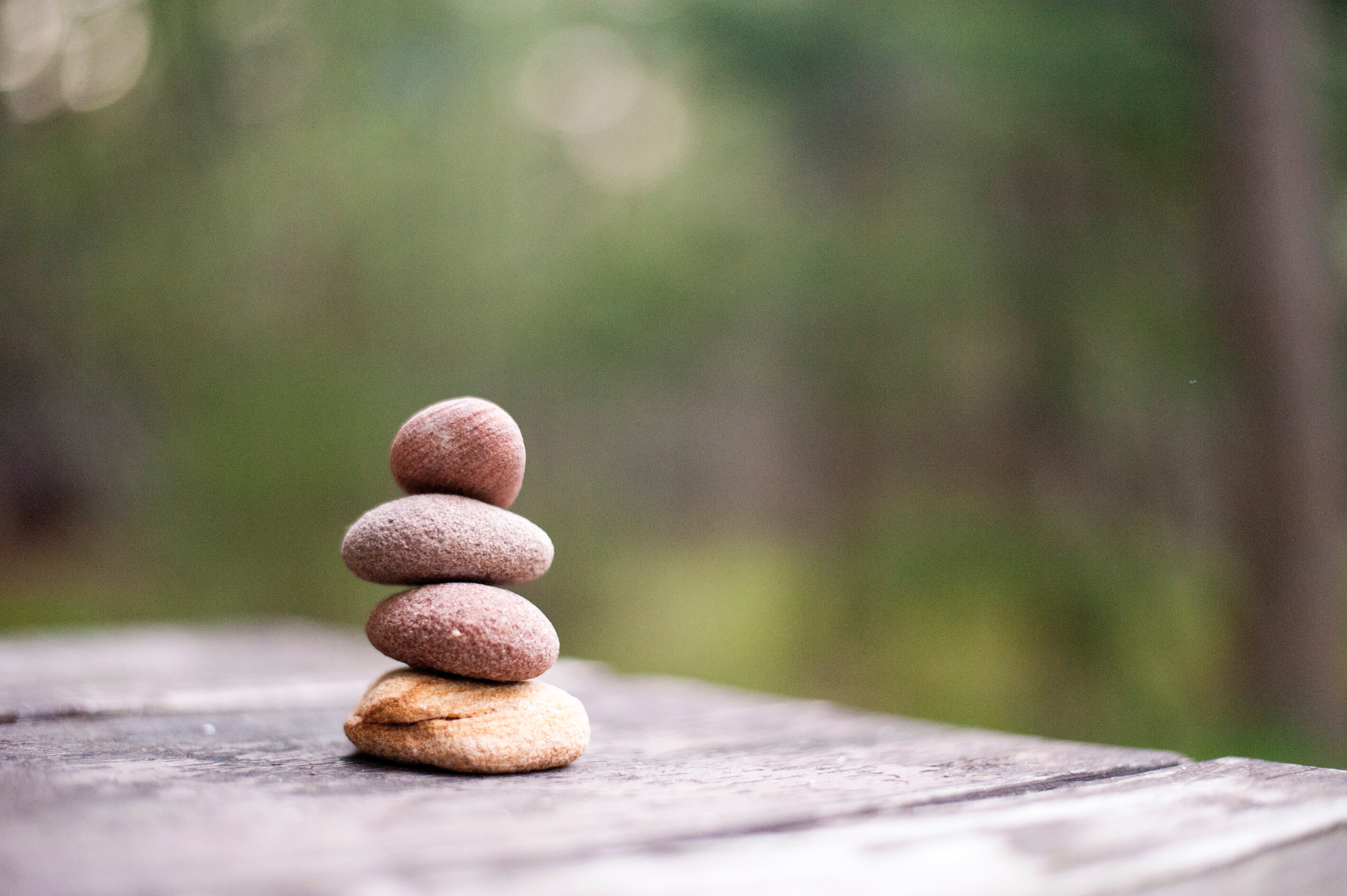 Cover image of a stack of four rocks on a wooden table